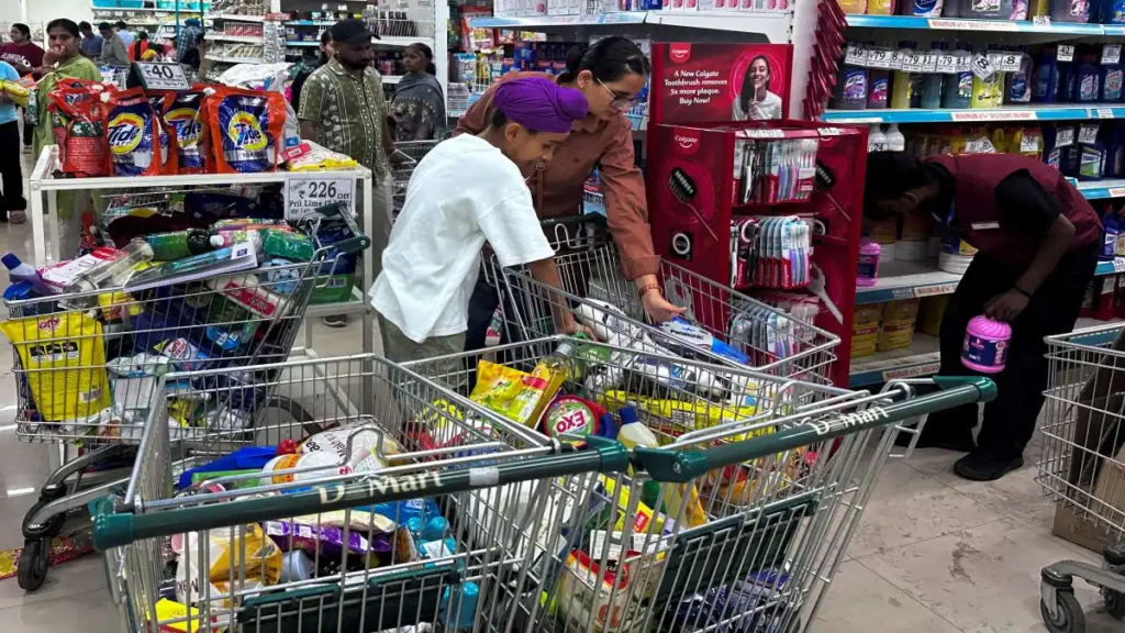People shop for essential goods at a supermarket in Amritsar