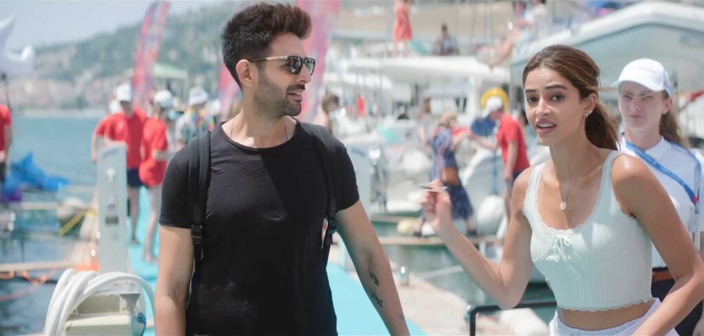 In Tu Meri Main Tera Main Tera Tu Meri, Kartik Aaryan plays Ray, a charming and fun-loving young man navigating modern romance while balancing traditional family values. His character is full of energy, wit, and emotion, creating a relatable yet entertaining persona alongside Ananya Panday’s Rumi in this lively rom-com